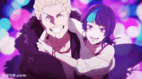 A Man And A Woman Are Posing For A Picture And The Woman Has Purple Hair . GIF