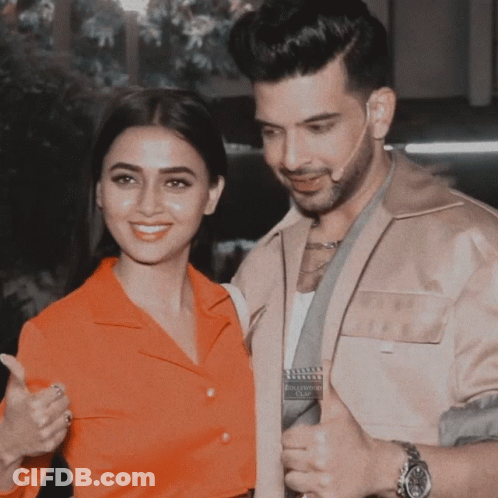 A Man And A Woman Are Posing For A Picture And The Woman Is Wearing A Red Shirt GIF