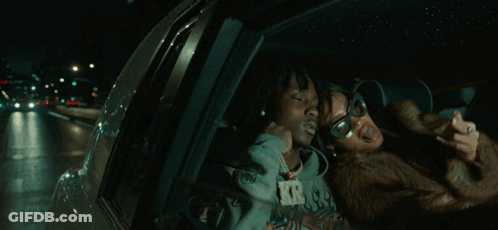 A Man And A Woman Are Posing For A Picture And The Woman Is Wearing Sunglasses GIF