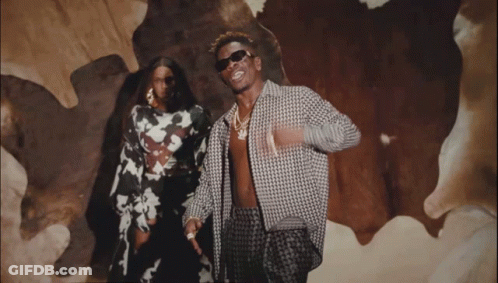 A Man And A Woman Are Posing For A Picture GIF