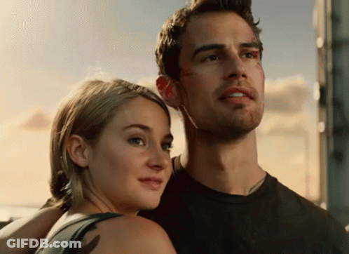 A Man And A Woman Are Posing For A Picture GIF