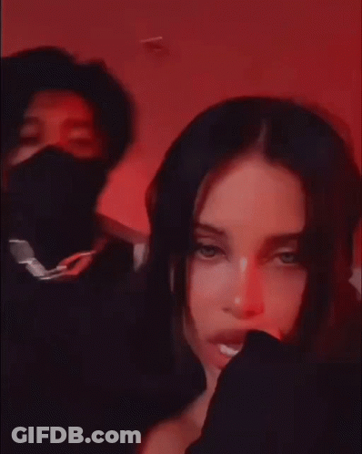 A Man And A Woman Are Posing For A Picture . The Woman Is Wearing A Black Mask . GIF