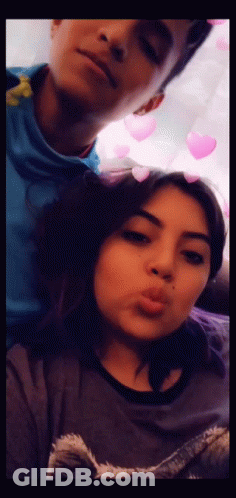 A Man And A Woman Are Posing For A Picture Together GIF