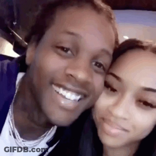 A Man And A Woman Are Posing For A Picture Together And Smiling For The Camera . GIF