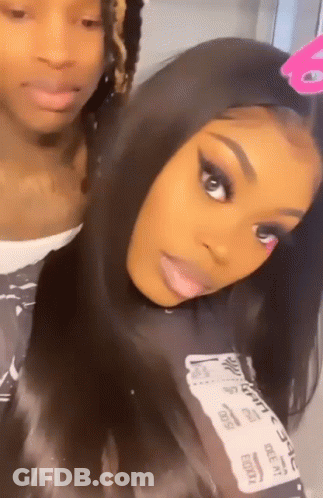 A Man And A Woman Are Posing For A Picture . GIF