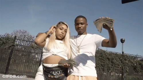 A Man And A Woman Are Posing For A Picture While Holding Money GIF