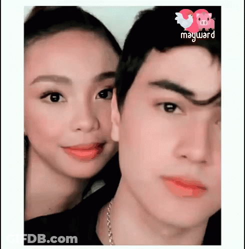 A Man And A Woman Are Posing For A Picture With The Word Mayward On The Bottom GIF