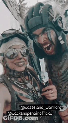A Man And A Woman Are Posing For A Picture With The Words Wasteland Warriors At The Bottom GIF