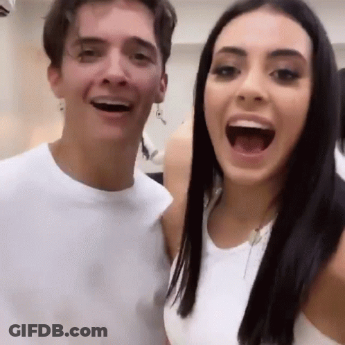A Man And A Woman Are Posing For A Picture With Their Mouths Open And Smiling . GIF