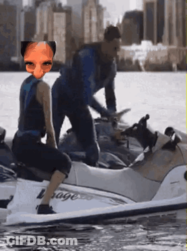A Man And A Woman Are Riding A Jet Ski With The Word Rage On It GIF