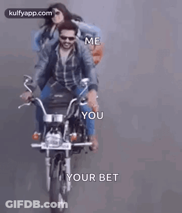 A Man And A Woman Are Riding A Motorcycle . GIF