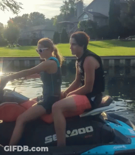 A Man And A Woman Are Riding A Se400 Jet Ski In The Water GIF