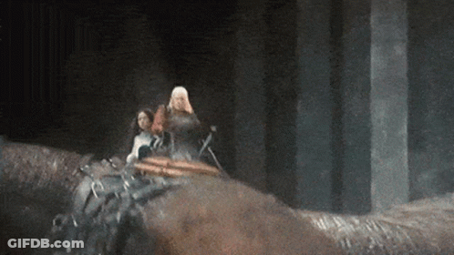 A Man And A Woman Are Riding On The Back Of A Horse . GIF