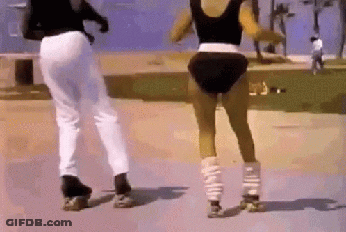 A Man And A Woman Are Rollerblading On A Sidewalk . GIF