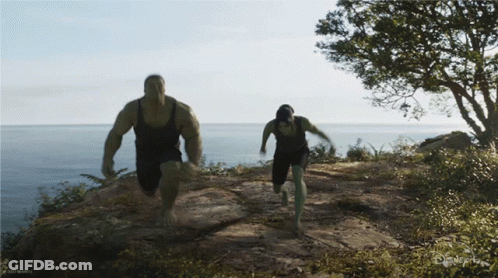 A Man And A Woman Are Running On A Trail With A Disney Logo In The Corner GIF
