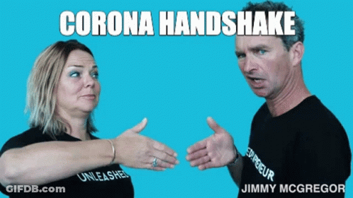A Man And A Woman Are Shaking Hands With The Words Corona Handshake Above Them GIF