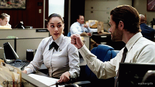 A Man And A Woman Are Sitting At A Desk With Walkergifs Written On The Bottom Right GIF