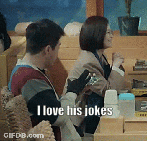 A Man And A Woman Are Sitting At A Table And The Man Is Saying I Love His Jokes GIF