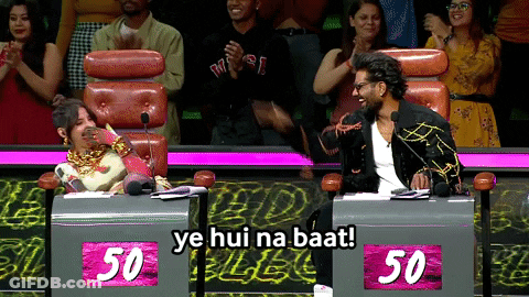 A Man And A Woman Are Sitting At A Table With 50 On It GIF