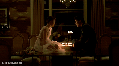 Man And Woman Sitting At Table With Cake GIF