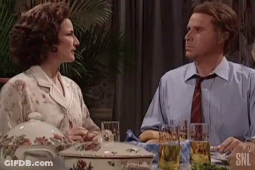 Man And Woman Sitting At Table With Casserole And Beer GIF