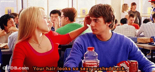 A Man And A Woman Are Sitting At A Table With A Coca Cola Bottle In Front Of Them . GIF