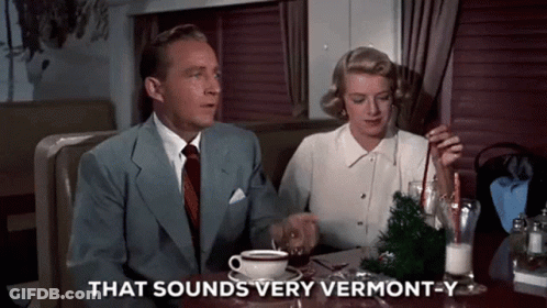 A Man And A Woman Are Sitting At A Table With A Cup Of Coffee And The Words That Sounds Very Vermont-Y GIF