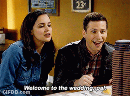 A Man And A Woman Are Sitting At A Table With The Man Saying Welcome To The Wedding Pal GIF