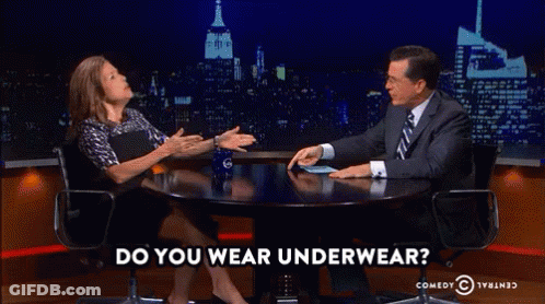 A Man And A Woman Are Sitting At A Table With The Words Do You Wear Underwear On The Bottom GIF