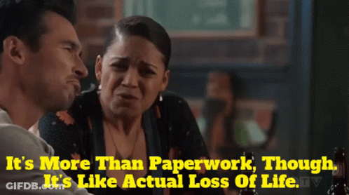 A Man And A Woman Are Sitting At A Table With The Words It 'S More Than Paperwork GIF