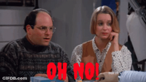 A Man And A Woman Are Sitting At A Table With The Words Oh No In Red Letters GIF