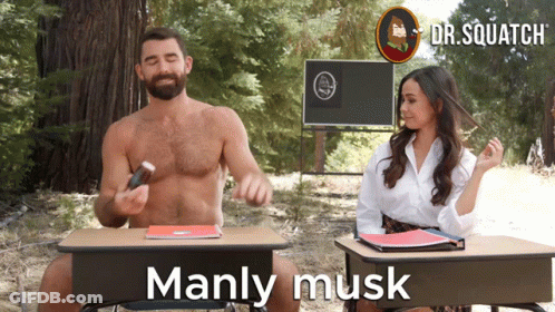 A Man And A Woman Are Sitting At Desks With The Words Manly Musk On The Bottom GIF