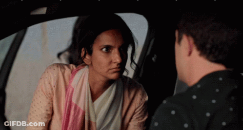 A Man And A Woman Are Sitting In A Car GIF