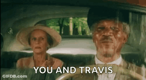 A Man And A Woman Are Sitting In A Car And The Man Is Driving . GIF