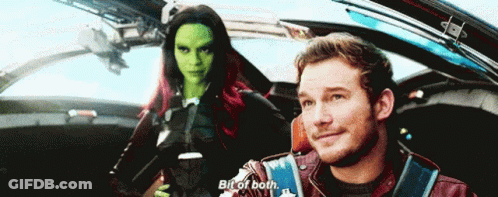 A Man And A Woman Are Sitting In A Car And The Man Is Saying Bit Of Both GIF