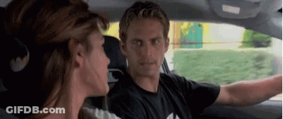 A Man And A Woman Are Sitting In A Car . GIF