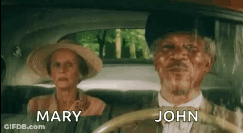 A Man And A Woman Are Sitting In A Car . The Man Is Driving And The Woman Is Sitting In The Back Seat . GIF