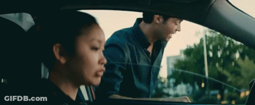 A Man And A Woman Are Sitting In A Car . The Woman Is Looking Out The Window . GIF
