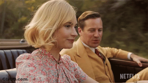 A Man And A Woman Are Sitting In A Car With Netflix Written On The Bottom Right GIF