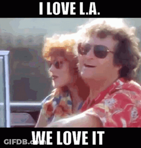 A Man And A Woman Are Sitting In A Car With The Caption I Love La We Love It GIF