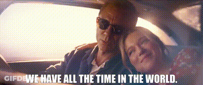 A Man And A Woman Are Sitting In A Car With The Words `` We Have All The Time In The World '' Above Them . GIF