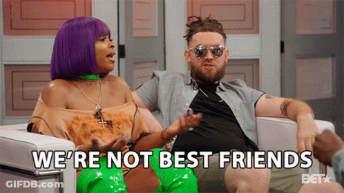 A Man And A Woman Are Sitting In A Chair With The Words We 'Re Not Best Friends Behind Them GIF
