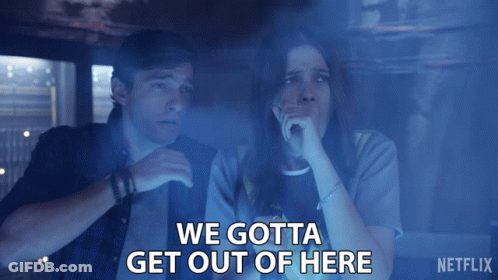 A Man And A Woman Are Sitting In A Dark Room With The Words " We Gotta Get Out Of Here " Above Them GIF