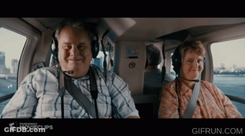 Man And Woman In Helicopter With Fandango Ad GIF