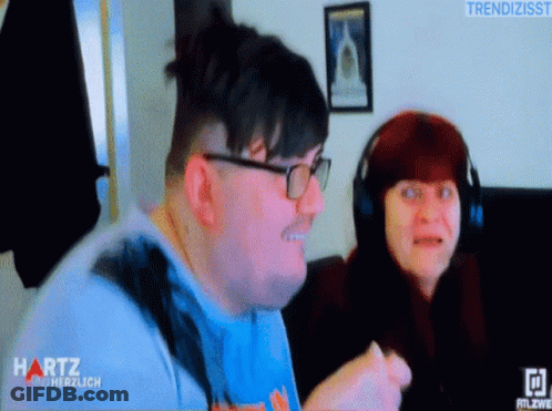 Man And Woman Sitting In Front Of Hartz Screen GIF