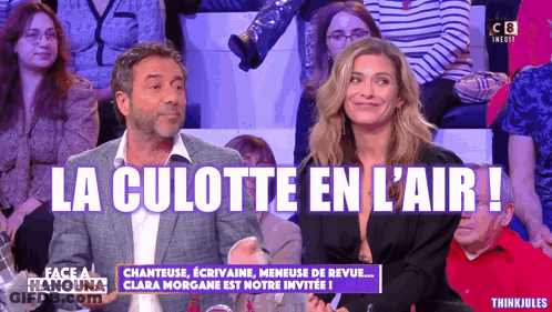 A Man And A Woman Are Sitting In Front Of A Crowd And The Words La Culotte En L' Air Are On The Screen GIF