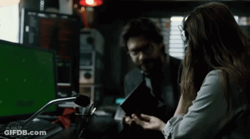 A Man And A Woman Are Sitting In Front Of A Green Screen With The Word Planeta On It GIF