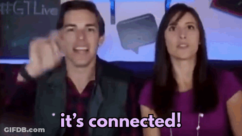 A Man And A Woman Are Sitting In Front Of A Sign That Says It 'S Connected .. GIF