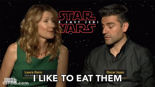 A Man And A Woman Are Sitting In Front Of A Star Wars Sign GIF