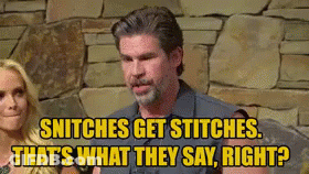 A Man And A Woman Are Sitting In Front Of A Stone Wall . GIF